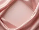 Blush pink satin folds framing a smooth pale pink center with open space for a design