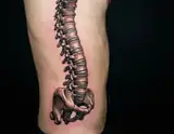 A hyperrealistic tattoo of a human spine and pelvis rendered in metallic bronze tones on a person's side against a black background.