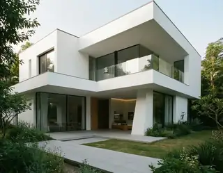 A modern white house with clean lines and glass balconies stands amidst lush greenery under a soft sky.