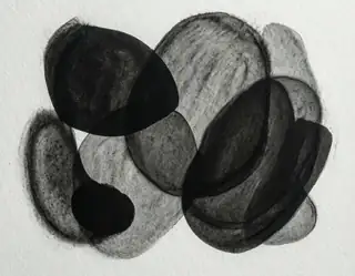 Rounded overlapping charcoal shapes in black and gray on textured white paper